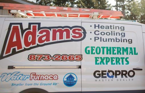 Adams Heating, Cooling & Plumbing service van with company brand and logos parked outside