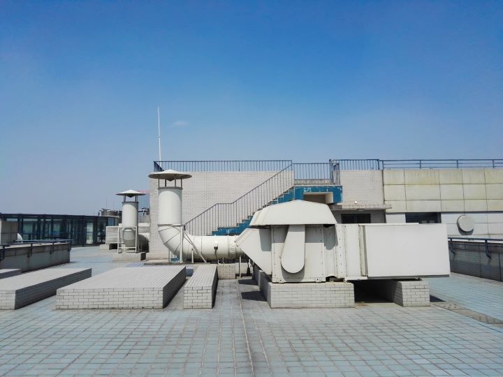 Rooftop with industrial HVAC ducts, vents, and exhaust units